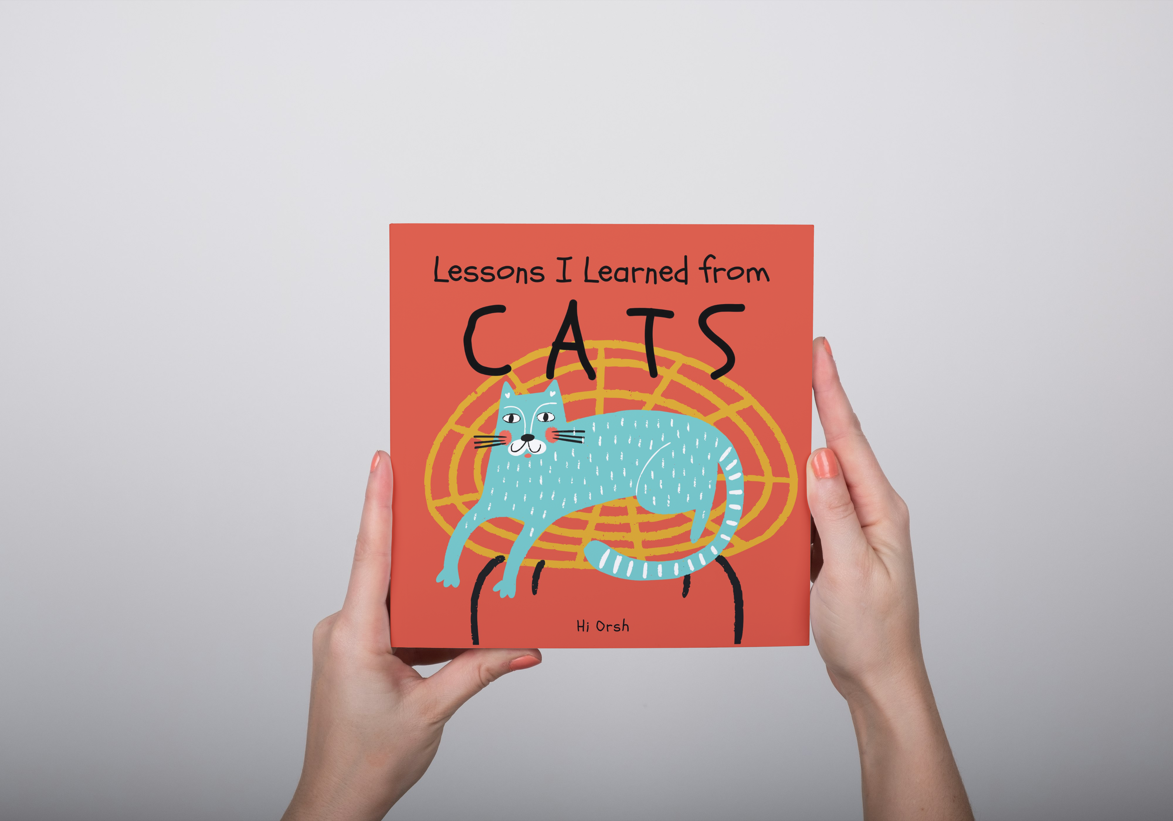 Hands holding Lessons I Learned from Cats children's book by Hi Orsh